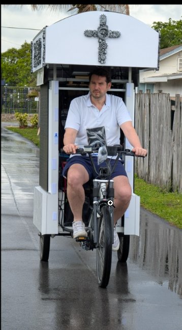 Matt riding his mobile GodGears cross display for street evangelism